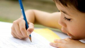 Young boy enjoying his his writing as part of homework, outdoors.; Shutterstock ID 3495342; PO: TODAY.com